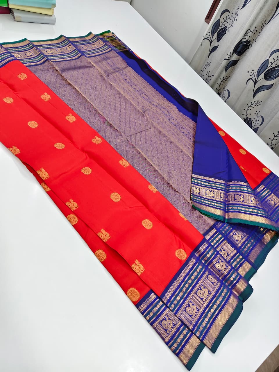 Handloom Kanchipuram Silk Saree with a traditional contrast border and buttas.